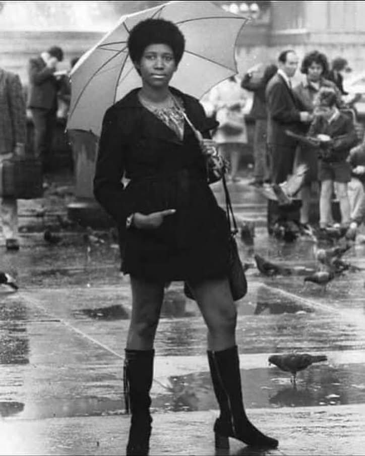 Aretha Franklin posing with an umbrella 