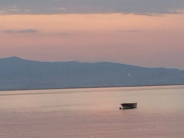 Boat adrift on the Aegean at sunset
