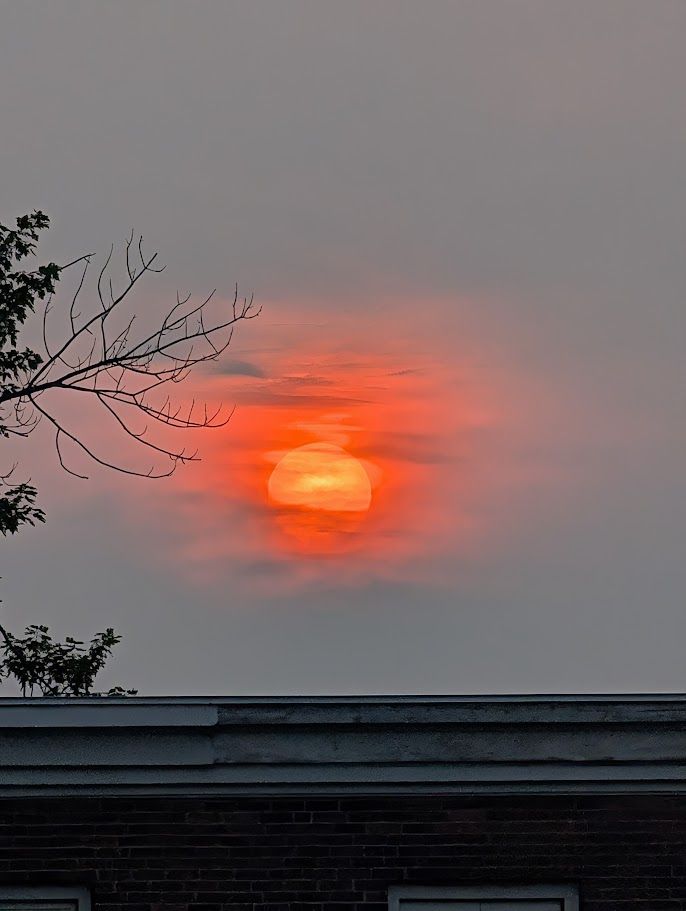 Red sun seen through clouds and haze