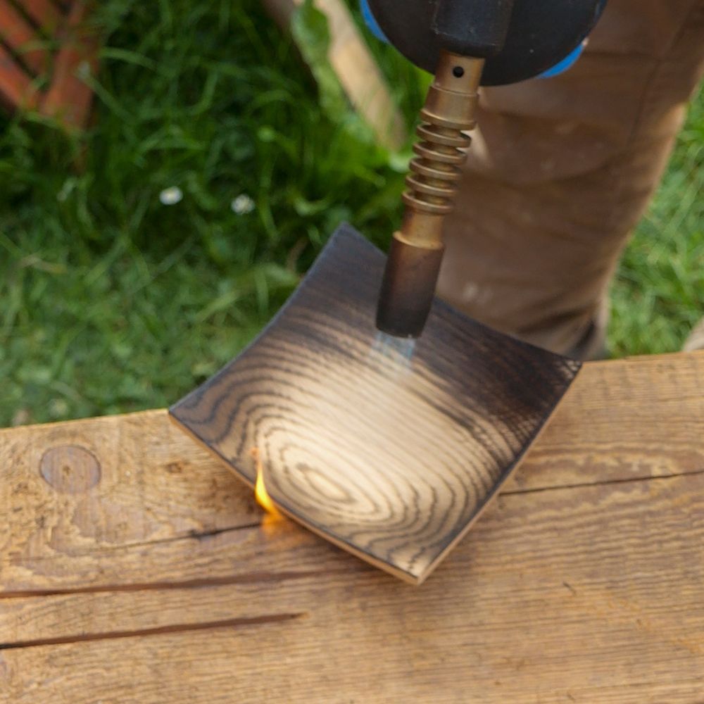 Charring the bowl using a blowtorch.
