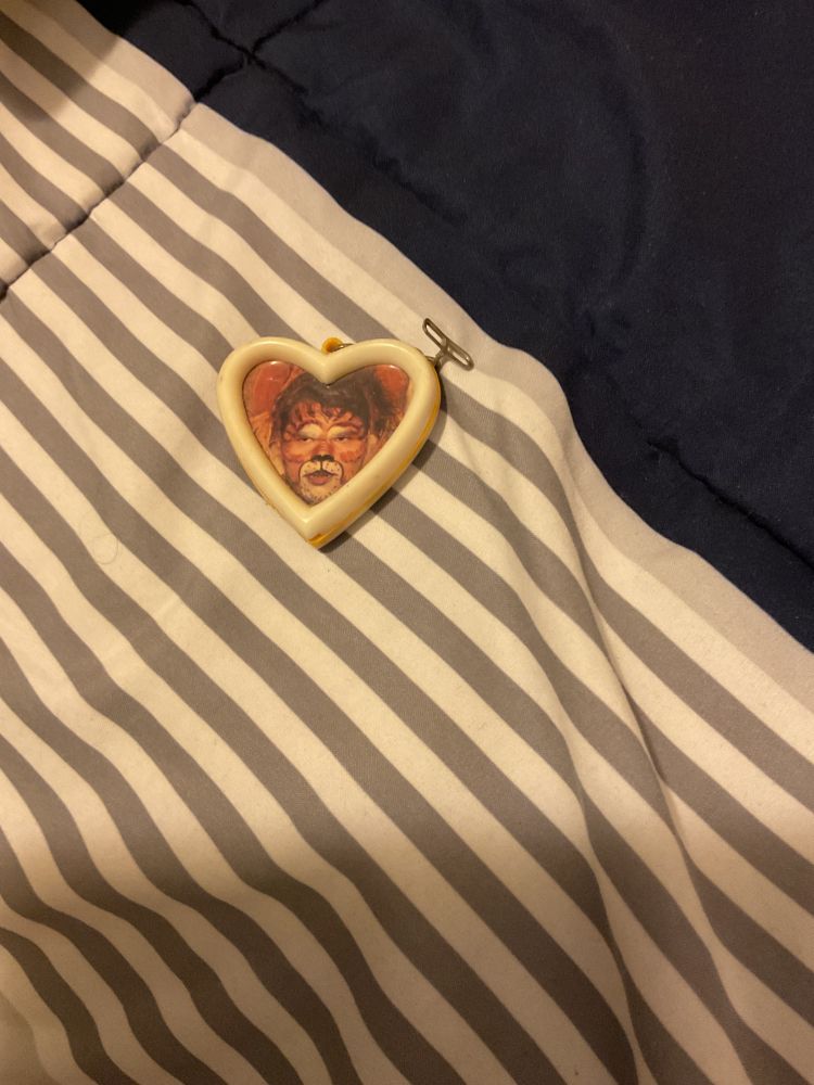 Picture of a gift locket I got in my special needs senior high school after I played the Cowardly Lion in our musical production of “The Wizard of Oz” showing a picture of my face in full makeup/costume