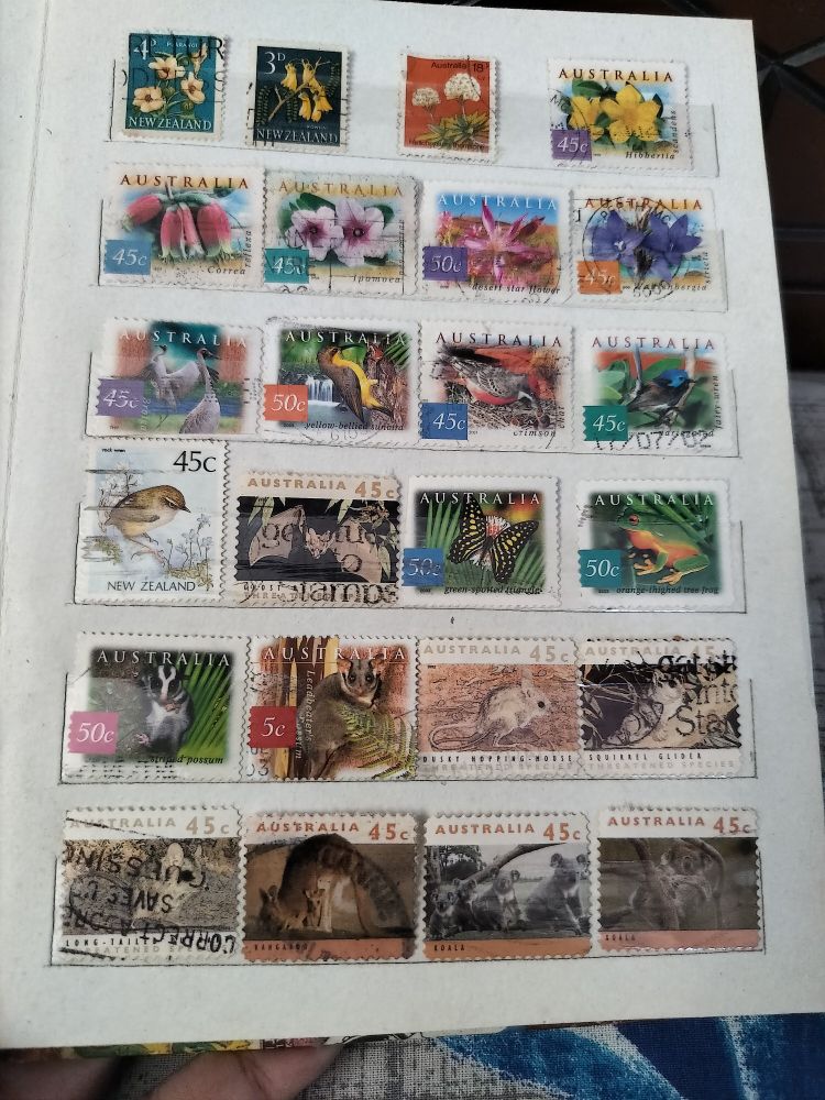 Postage stamps featuring flowers, birds, and animals.