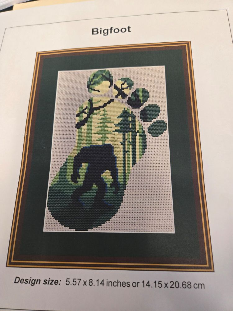 Bigfoot Silhouette in a footprint. Cross-stitch. Greens