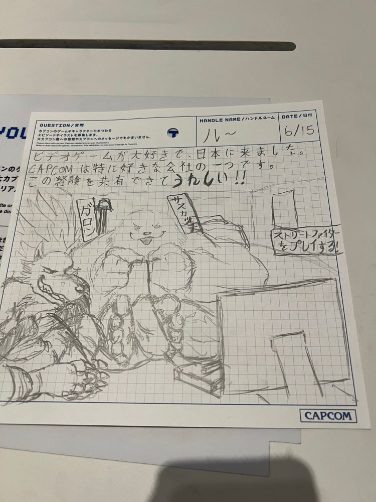 I wrote “I came to Japan because I love video games. Capcom is one of my favorite companies. I’m happy to share this experience.

I also included the Japanese names for Talbain and Sasquatch, along with something on the right side. “They’re playing street fighter.”