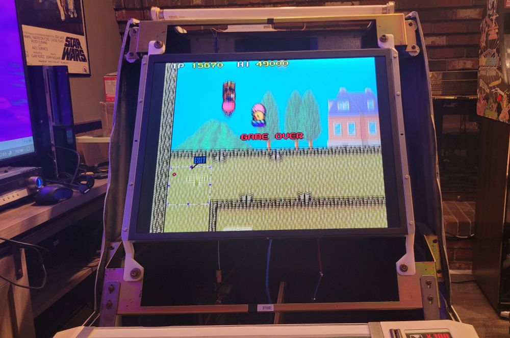 sega astro city cab without the screen bezel. it's been temporarily retrofitted with a 27" flat panel LCD. the marquee light is erroneously disconnected. new zealand story is displayed on-screen.