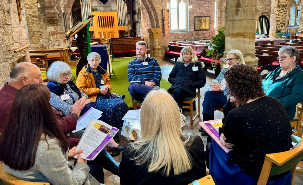A group of people sitting in a circle having an informal and relaxed discussion, inside St Mary's Church Ponteland