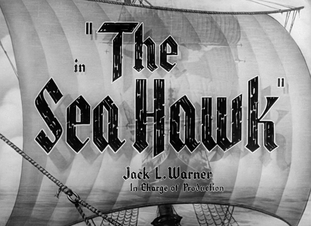 Title card from the movie "The Sea Hawk" (1940) displayed in blocky calligraphy against a sail of a ship
