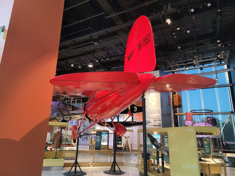 Aft view of red airplane showing empannage and monocoque after fuselage.