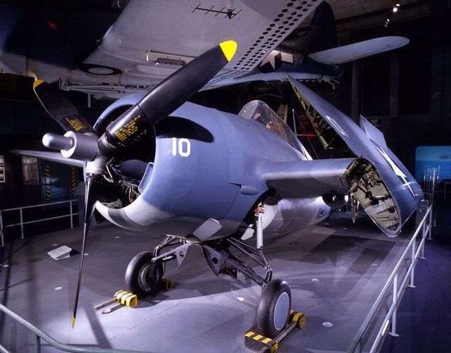 Eastern Division FM-1 Wildcat in WW2 Navy colors. On its gear, seen from 10 o'clock level, wings folded for carrier storage.