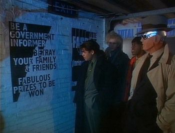 screenshot from an episode of Red Dwarf. 4 characters looking at a poster on the wall that reads

BE A GOVERNMENT INFORMER

BETRAY YOUR FAMILY & FRIENDS 

FABULOUS PRIZES TO BE WON