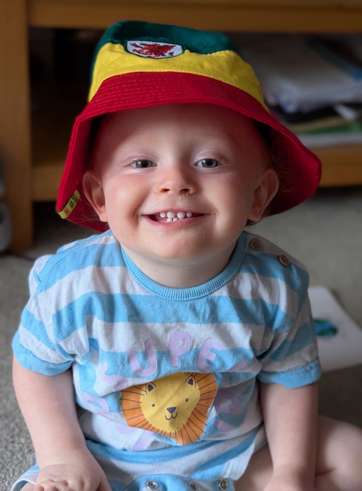 Baby in a Wales football bucket hat 