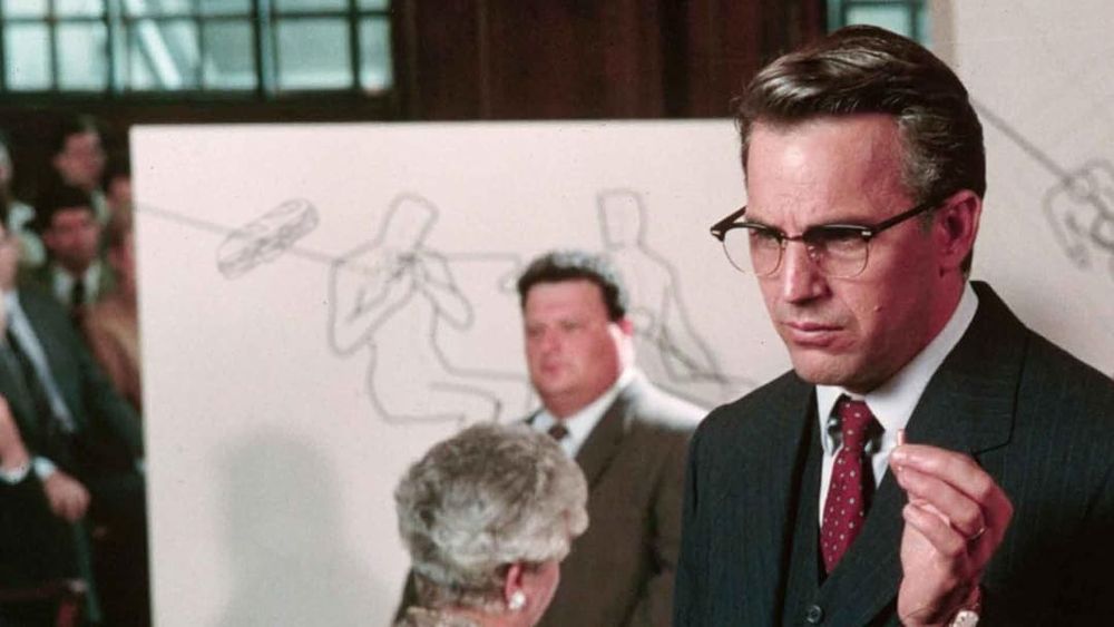 JFK movie scene lawyer arguing in foreground in the background is the Seinfeld newman actor (i think) by a big drawing of JFK assassination scene but I added a drawing of a subway sandwich.