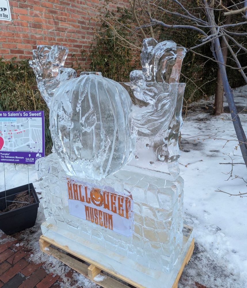 ice sculpture pumpkin by Halloween museum sign.