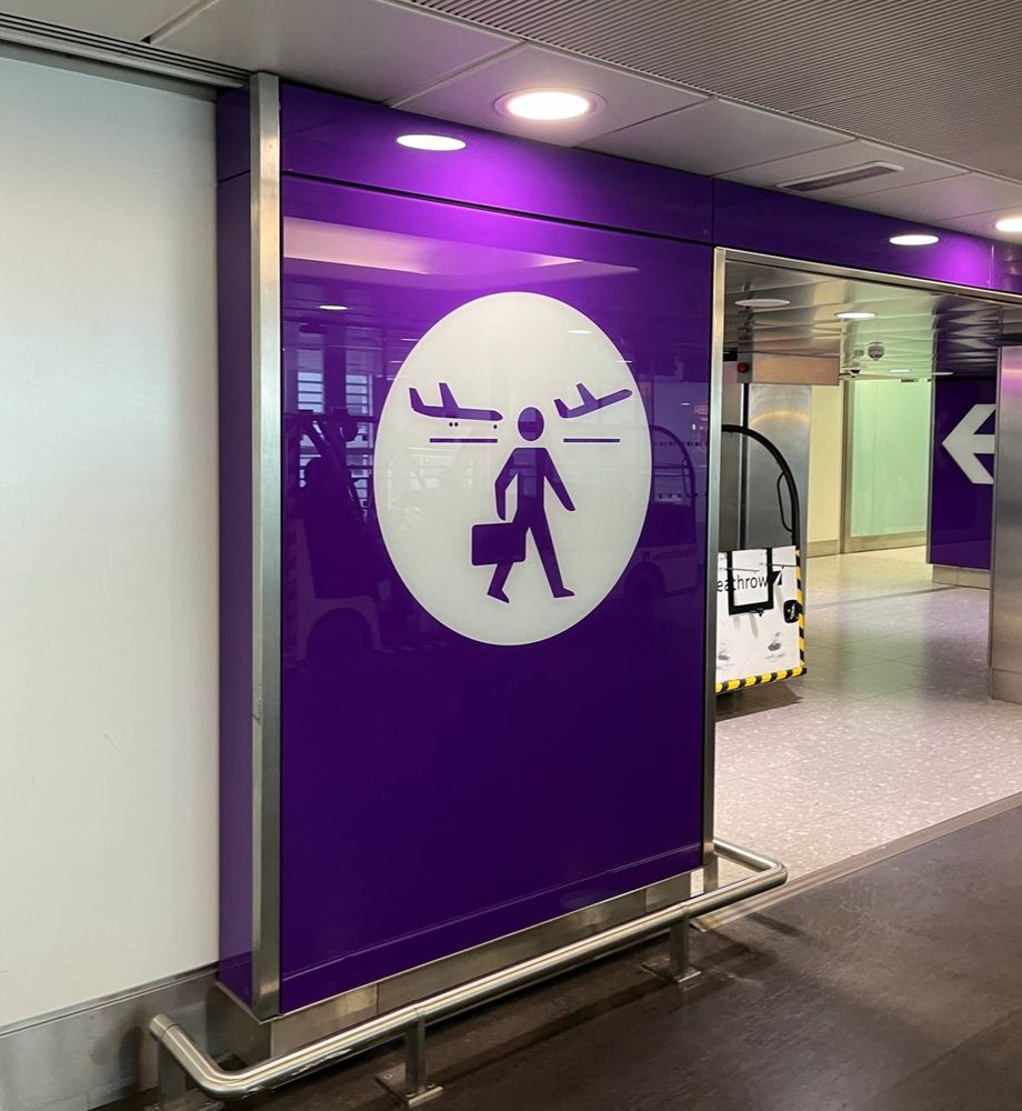 Sign indicating connecting flights that looks suspiciously like a person with antlers.