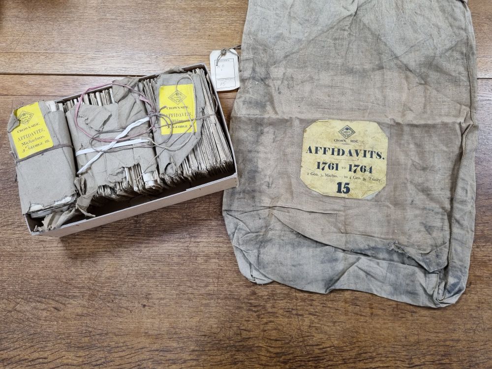 Bag for storing King's Bench affidavits, next to the affidavits themselves.