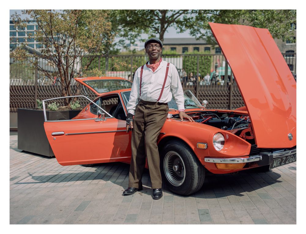 Portrait of a man in front of a classic car.