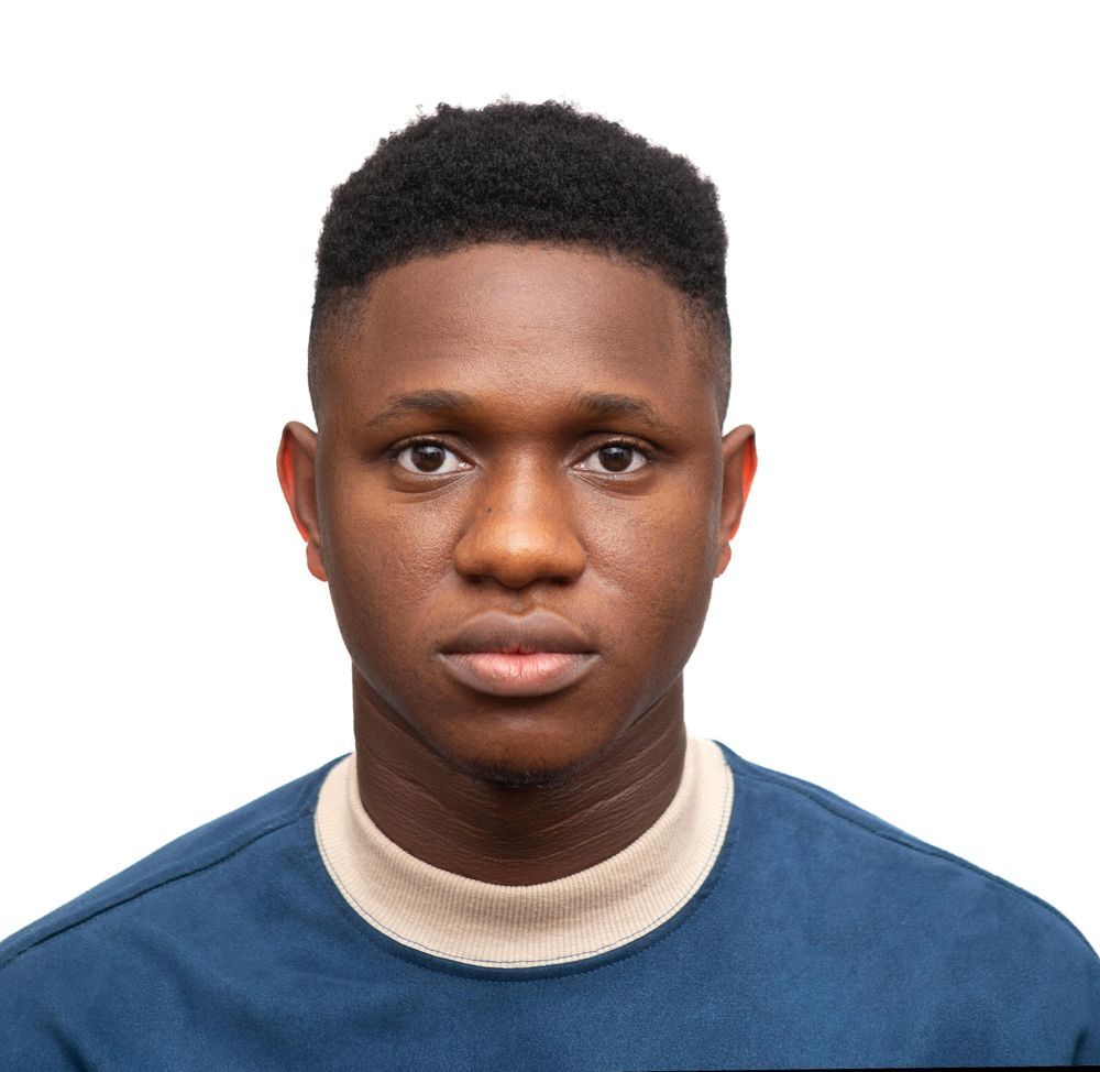 Face of a man. His facial expression is at best neutral. 