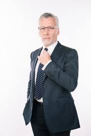 Nervous looking man in suit,  adjusting his tie