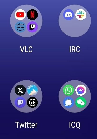 Apps organized in groups. Video streaming apps in a group called VLC. Discord and Slack in group called IRC. BlueSky, Threads, Mastodon and X in a group called Twitter. Messaging apps in a group called ICQ.