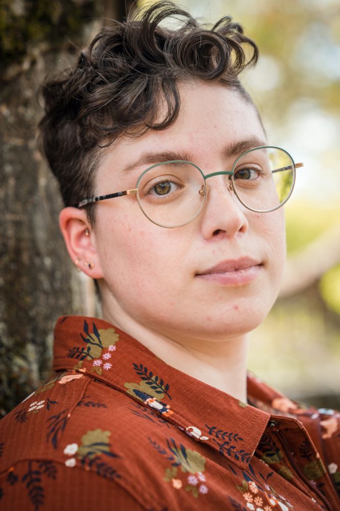 Headshot of a white woman with short curly hair