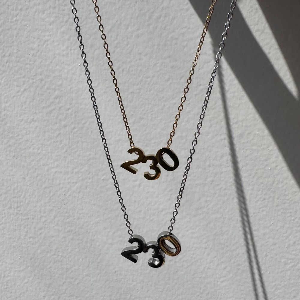 Gold and silver necklaces with 230 on them 