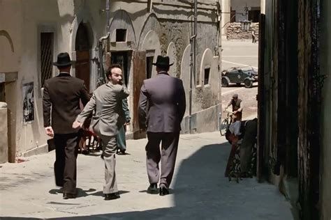 Life is Beautiful scene where the father is taken away from his child. He makes an exaggerated face and walk so his son will not be scared. 