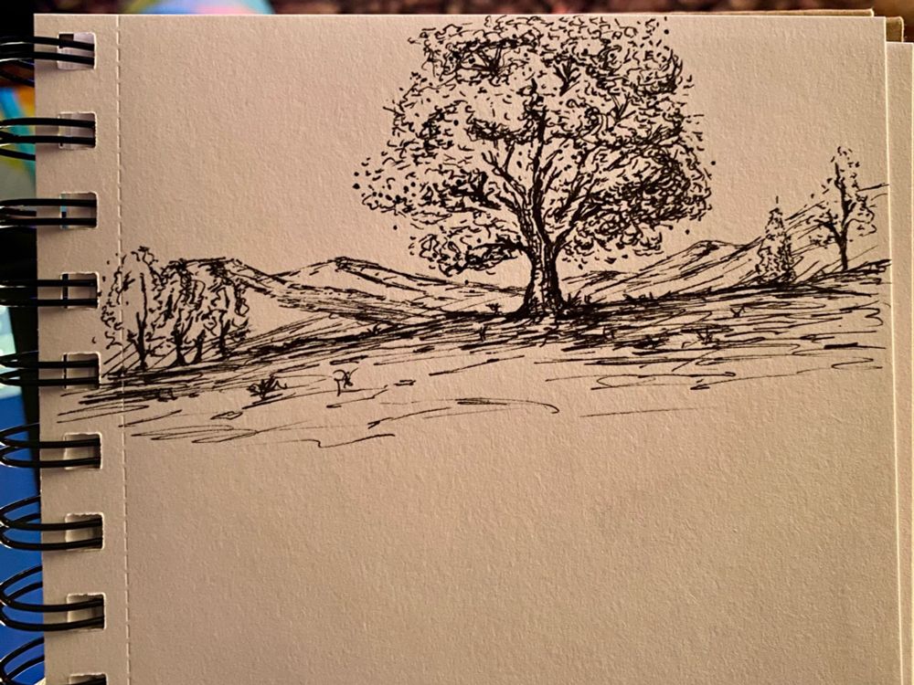 Hand drawn landscape featuring a large central tree in the foreground, smaller trees in the middle distance, and mountains in the background.