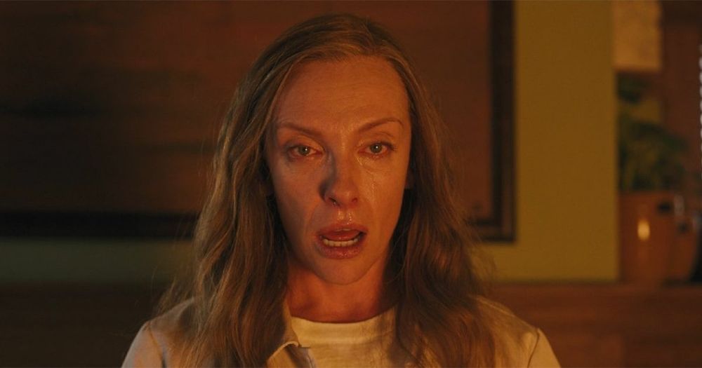 A screenshot from the 2018 horror film Hereditary depicting Annie Graham (played by Toni Collette) staring with a very dead-eyed expression and mouth agape.