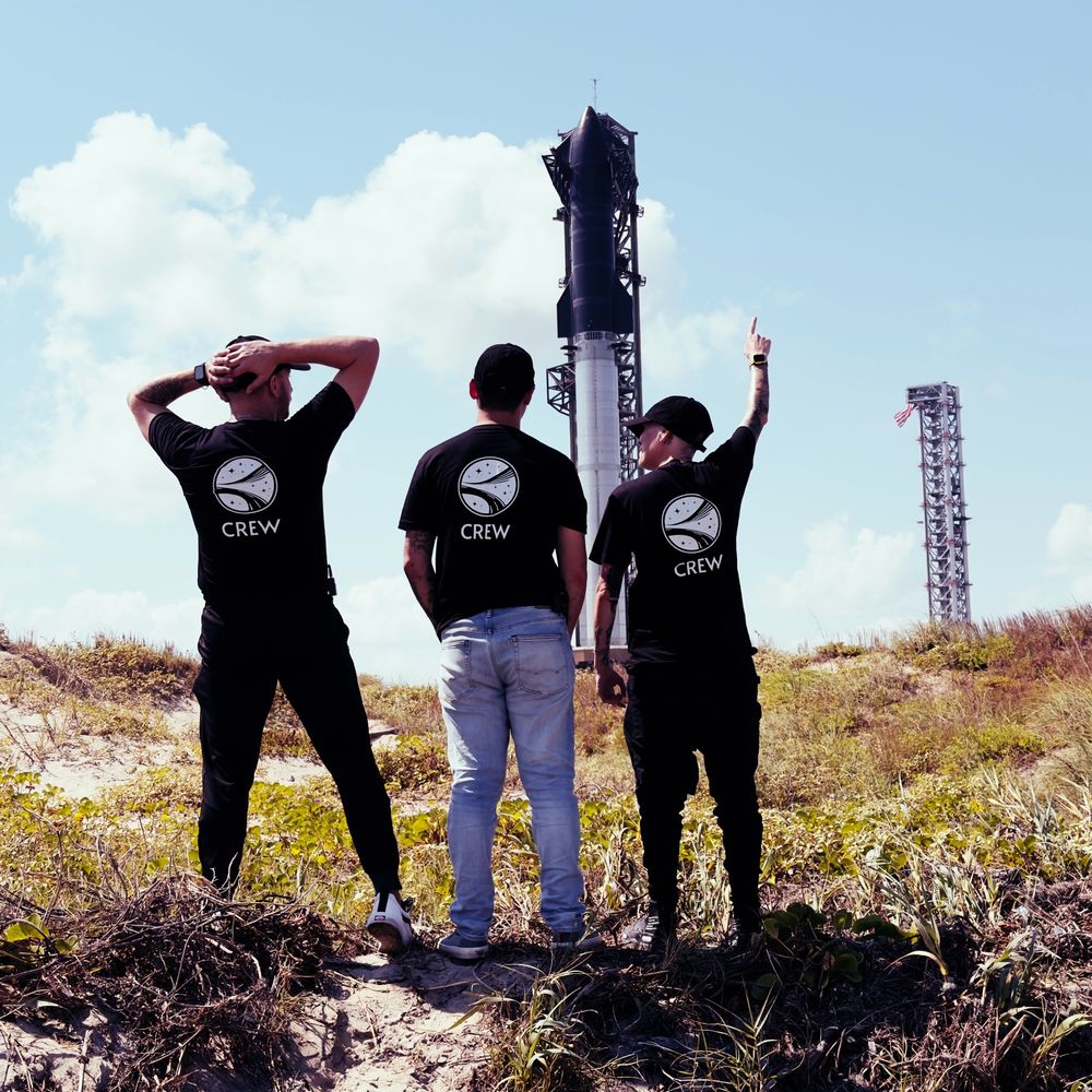 Team members standing in front of starship