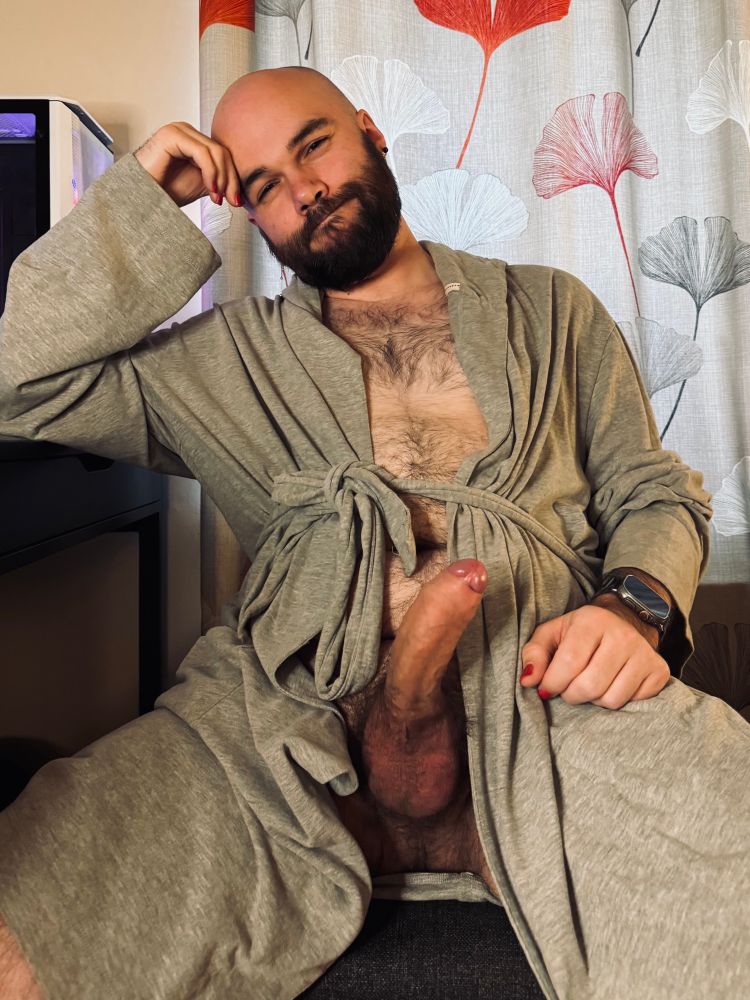 Me sitting at a desk in a dressing gown tied loosely around my waist, revealing a hard cock underneath