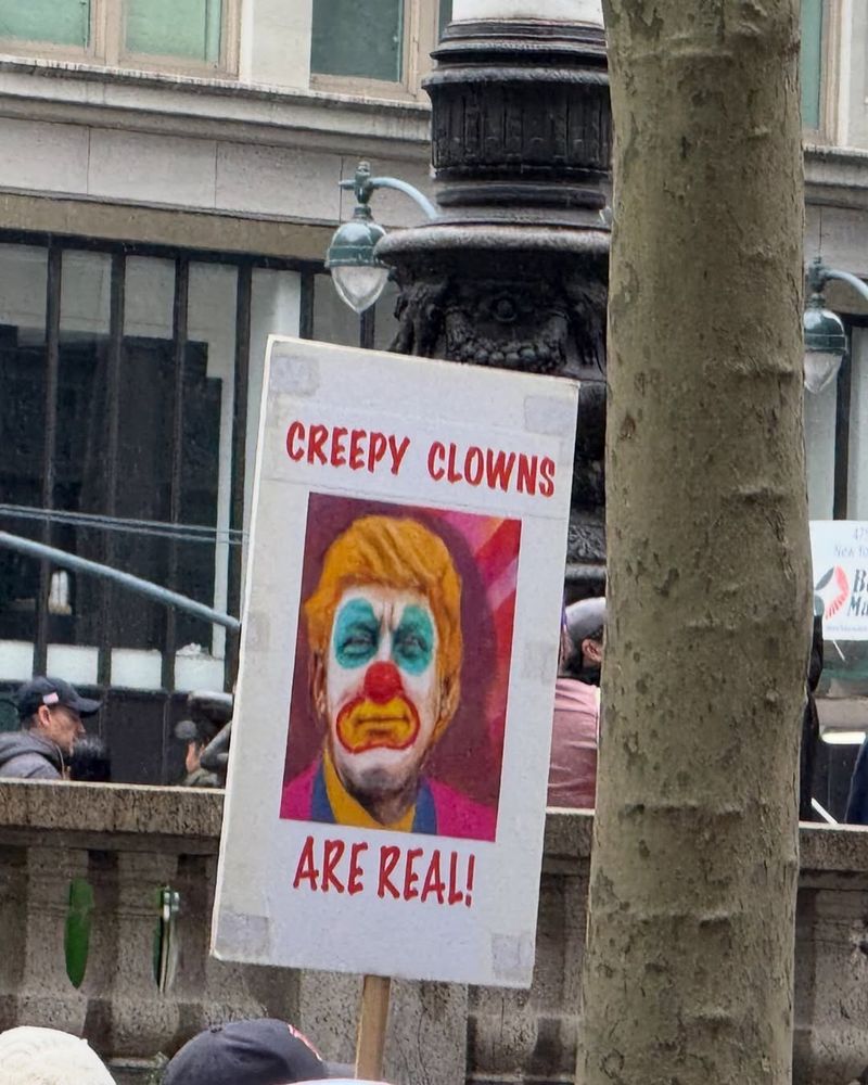 A protest sign reads "Creepy Clowns Are Real" and Trump is illustrated as a clown