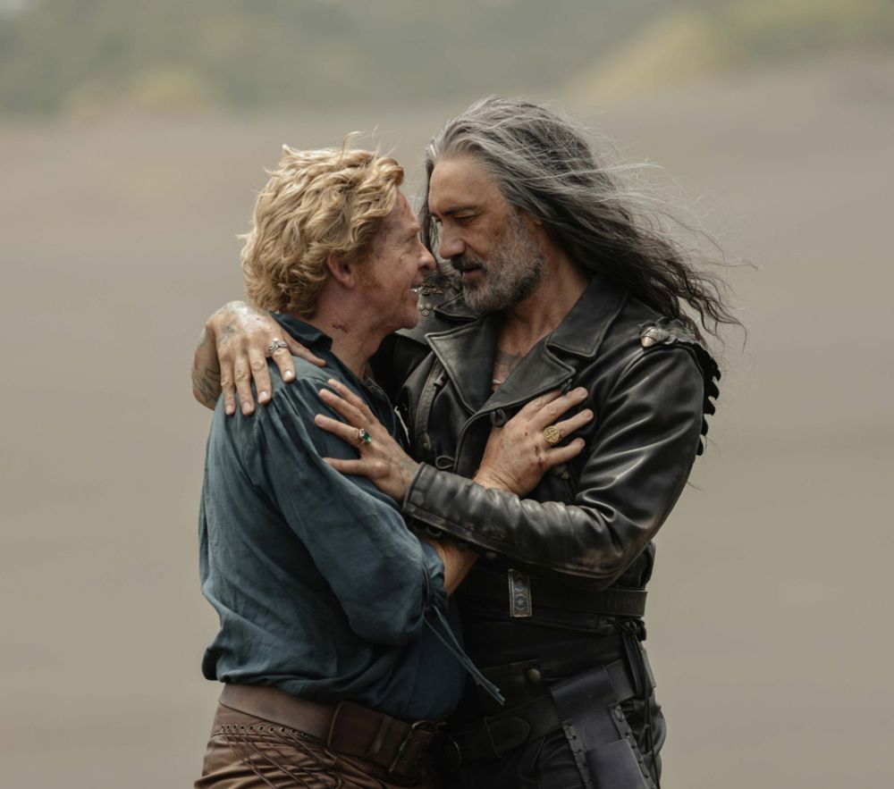picture of Ed and Stede from episode eight season two, they're on the beach holding each other and looking at each other
