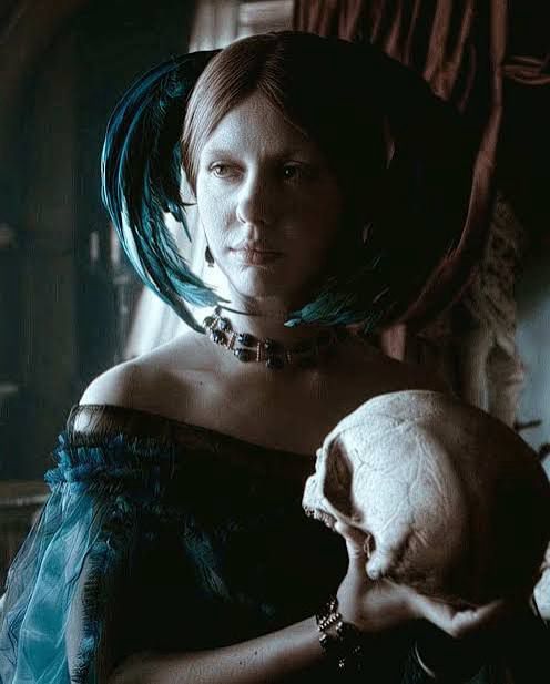 Still from Guillermo Del Toro’s Frankenstein, the Lady Elizabeth holding a skull