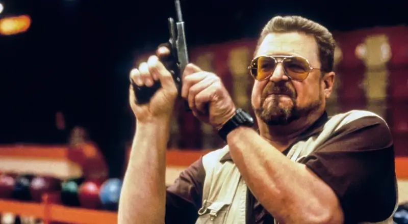 Walter Sobchak from The Big Lebowski angrily cocking a handgun