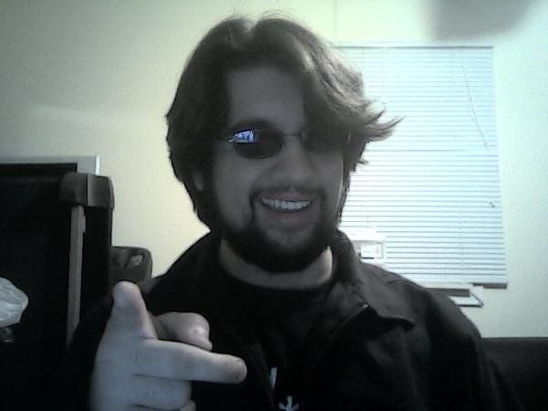 guy with sunglasses, a beard and a cool ass hair pointing at you with a shit eating grin in an room (it isn't me in real life if you are wondering lol)