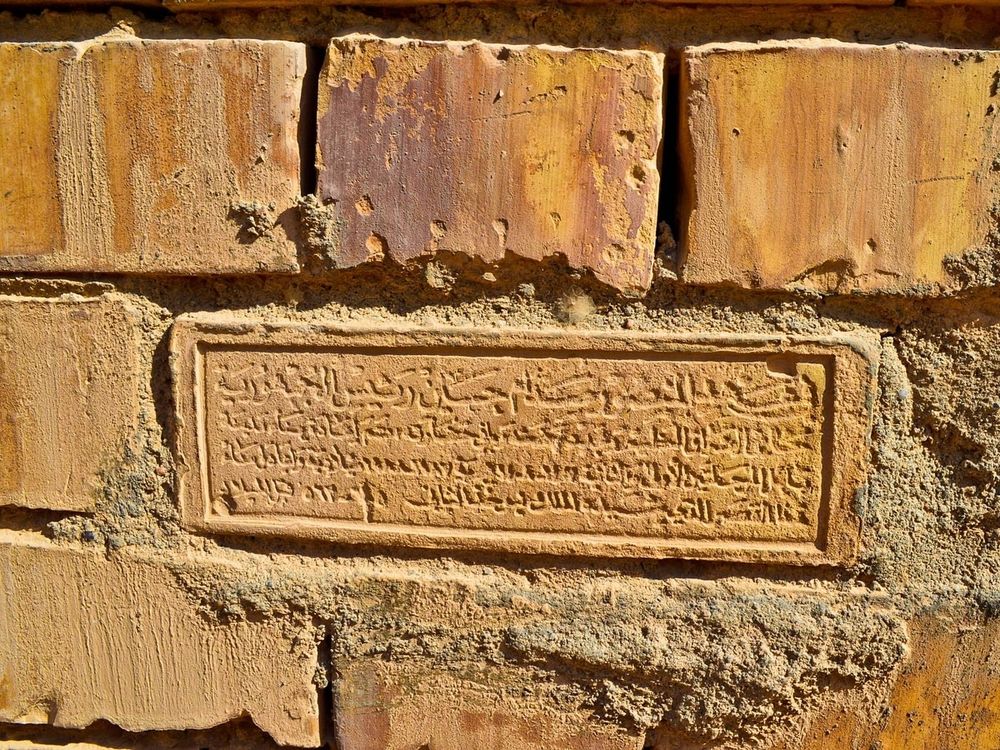 Saddam sets a brick mold into the walls of Babylon in the style of ancient kings.