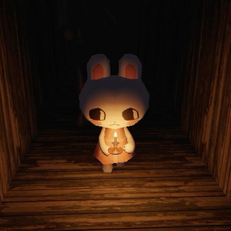 Bunny from 
Rental holding a candle and looking frightened in a dark room.