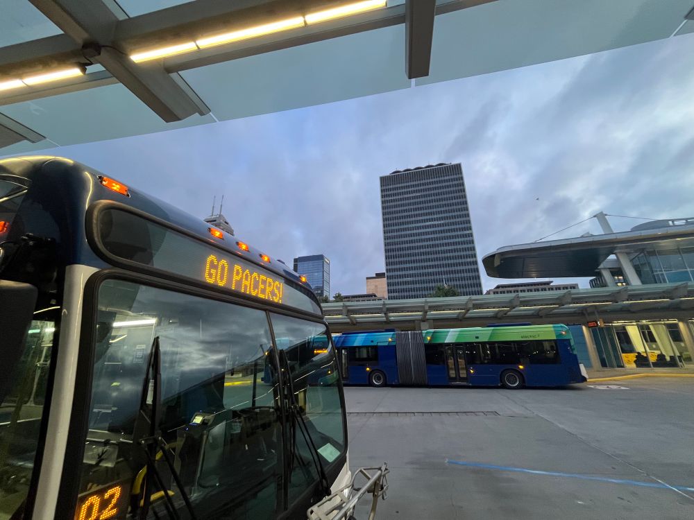 Bus at transit center, skyline in background 
