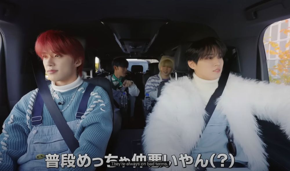 some of the jo1 members in the car. junki driving, ruki next to him, behind them: sho behind junki, syoya behind ruki.

the subtitle reads: [sho, continuation] they're always on bad terms