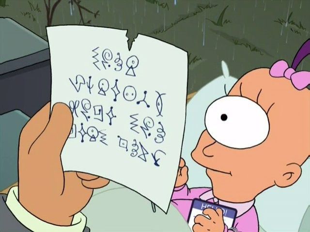 A cyclops baby in a basket. A hand holds a note written in an alien language in the foreground