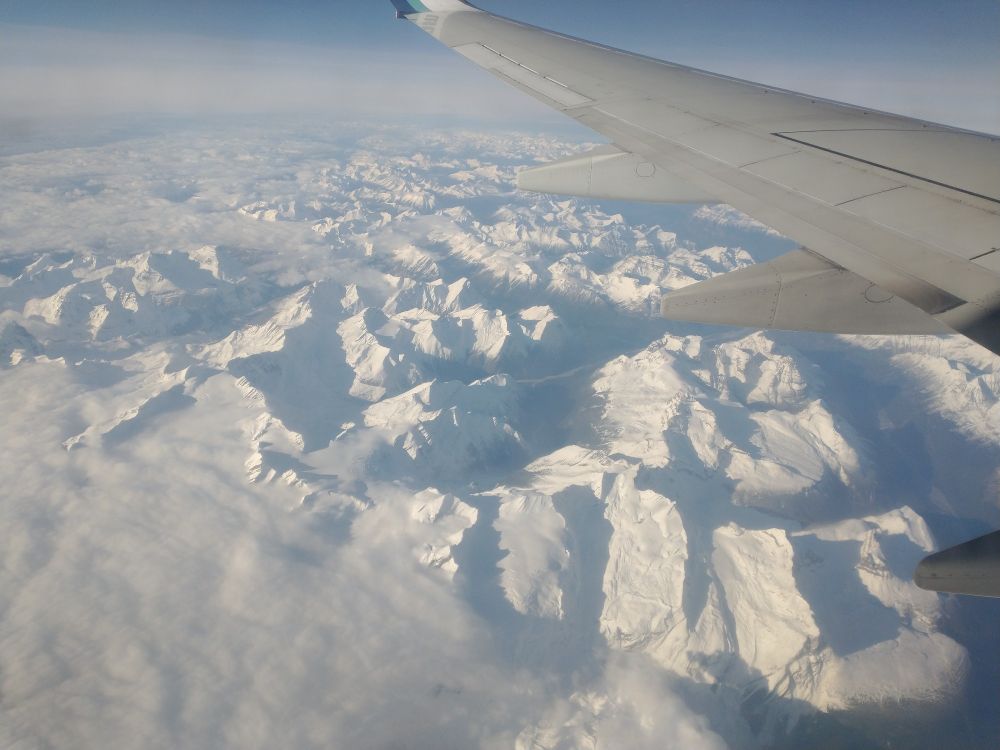 Image of snow covered mountains from a plane.