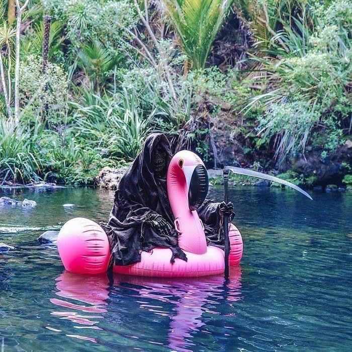 The grim reaper on a flamingo floatie