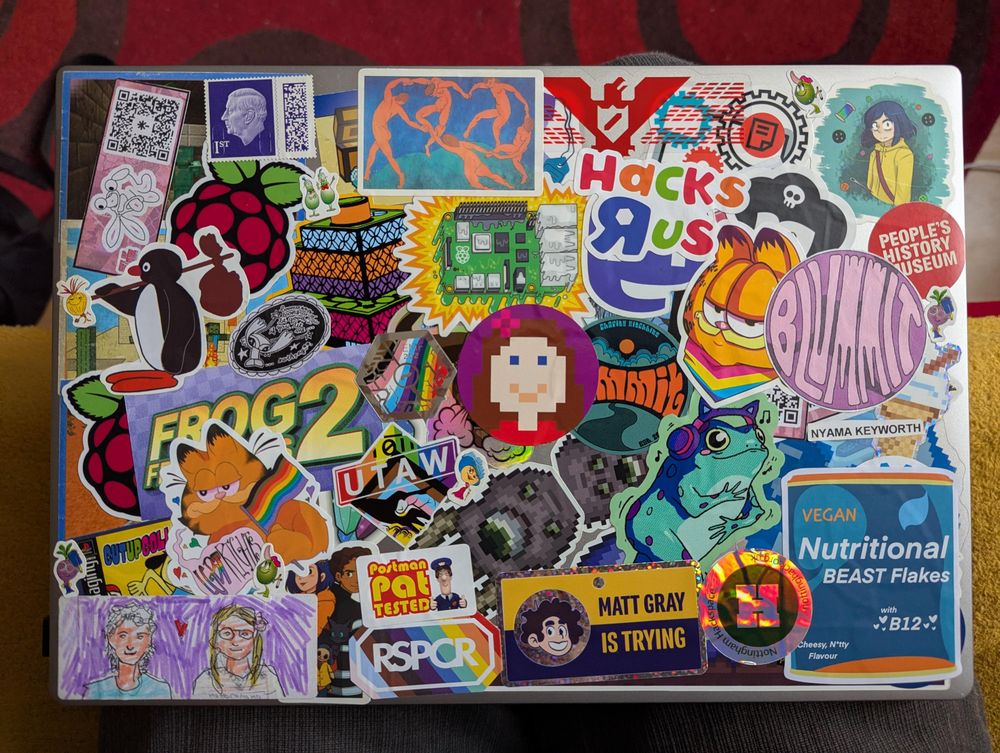 picture of laptop with many stickers on it, notably a new shiny Nottingham Hackspace one