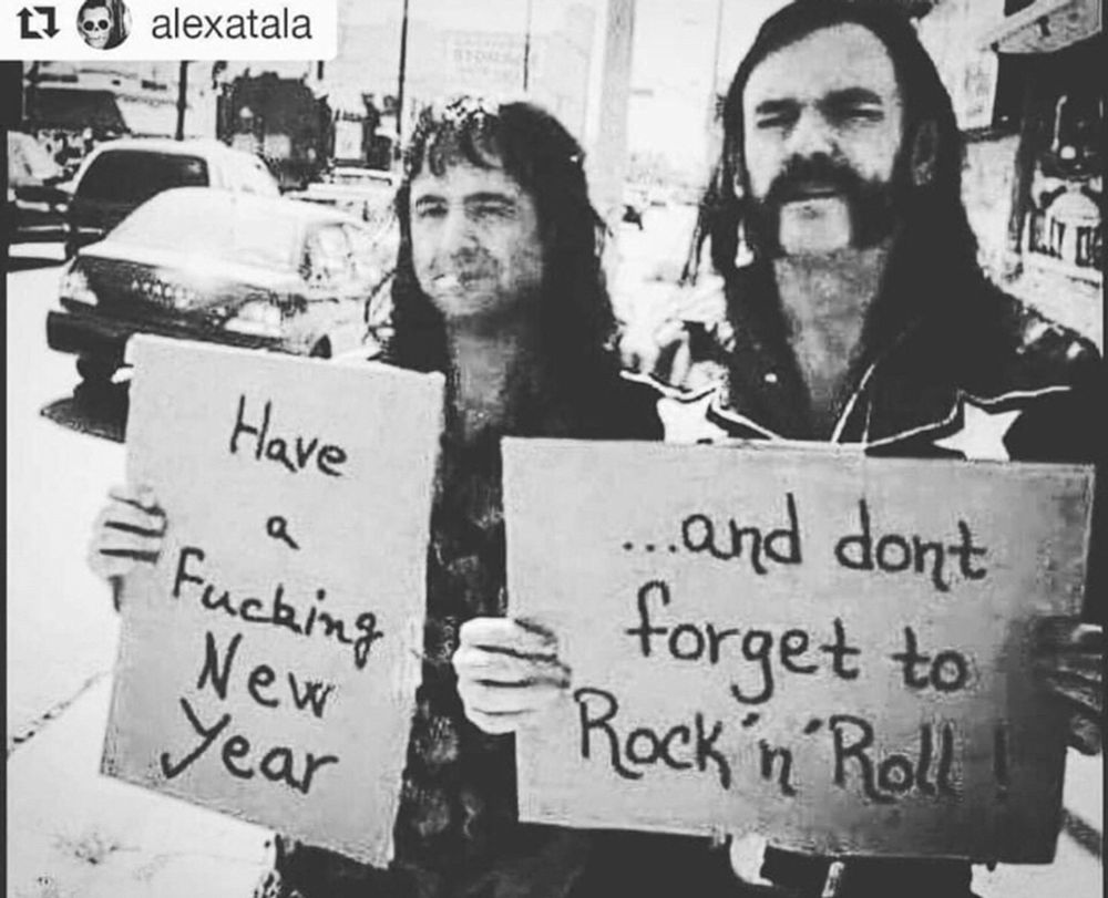 Lemmy and (I think) Mikky Dee from Motorhead holding signs that read "Have a fucking new year...and don't forget to rock n roll"