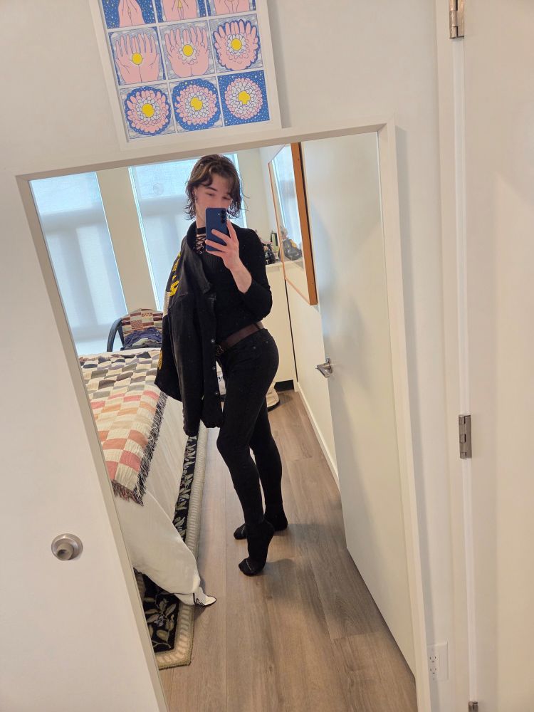 Ash stands popping their hip out to show a beautiful curve of their ass 