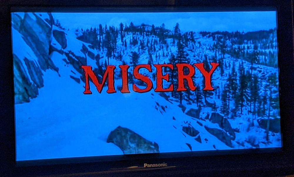 Television showing a snowy scene with the title Misery in red text.