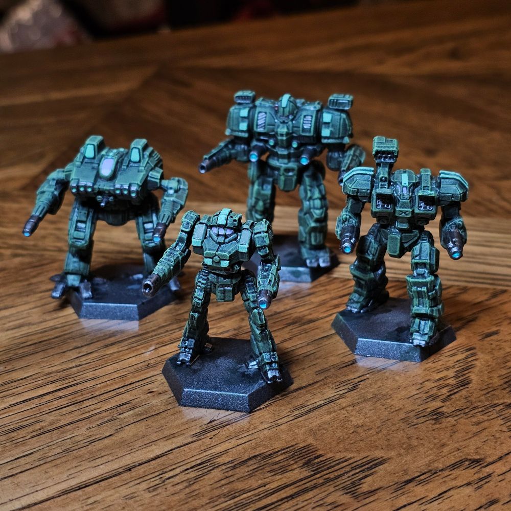 Four BattleTech plastic miniatures, painted in Federated Suns Second Crucis Lancers livery of Davion green with light green highlights. The miniatures represent a Penetrator, Enforcer, Devastator, and BattleAxe.