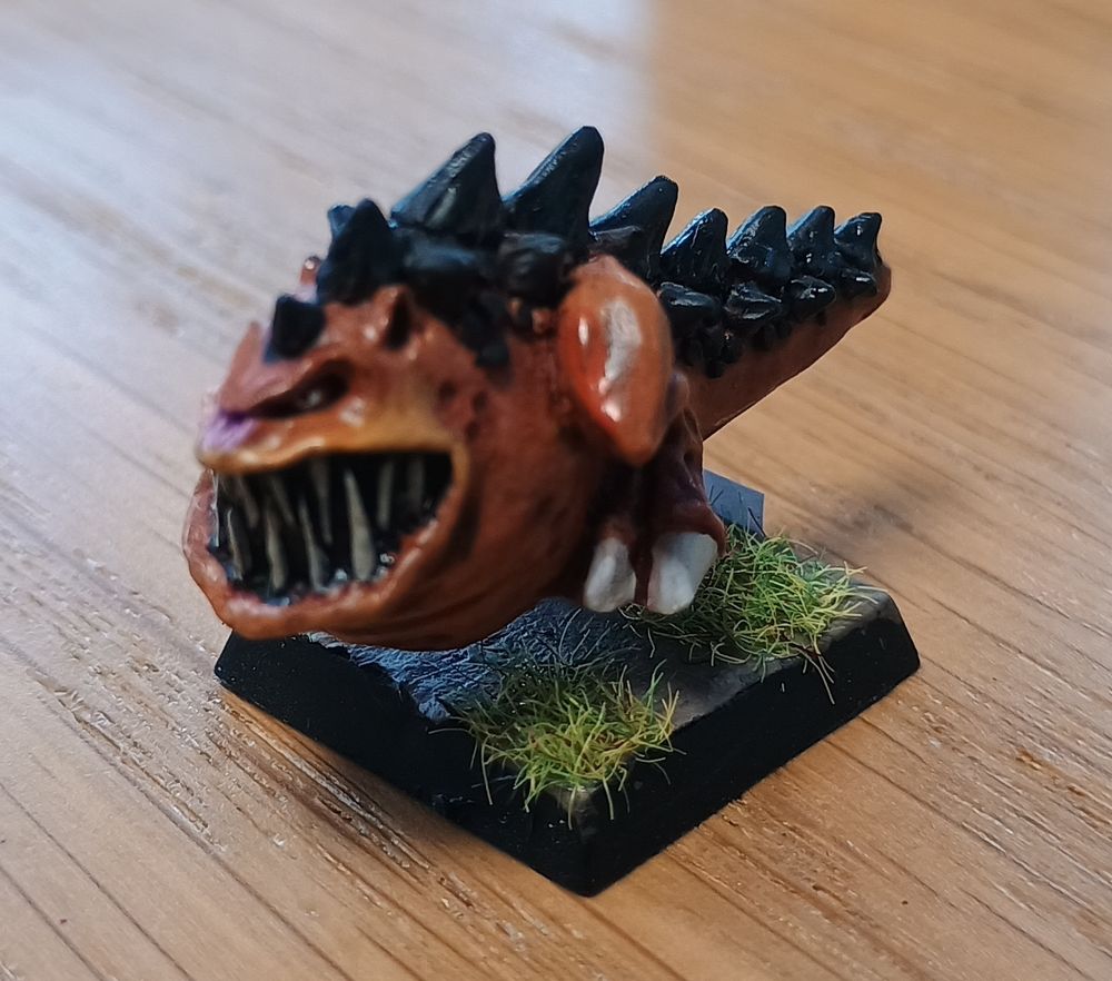 A Warhammer squig painted to look like Garfield