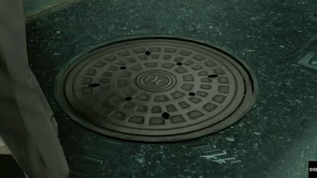 a video game scene with a manhole cover and a sign that says css on it