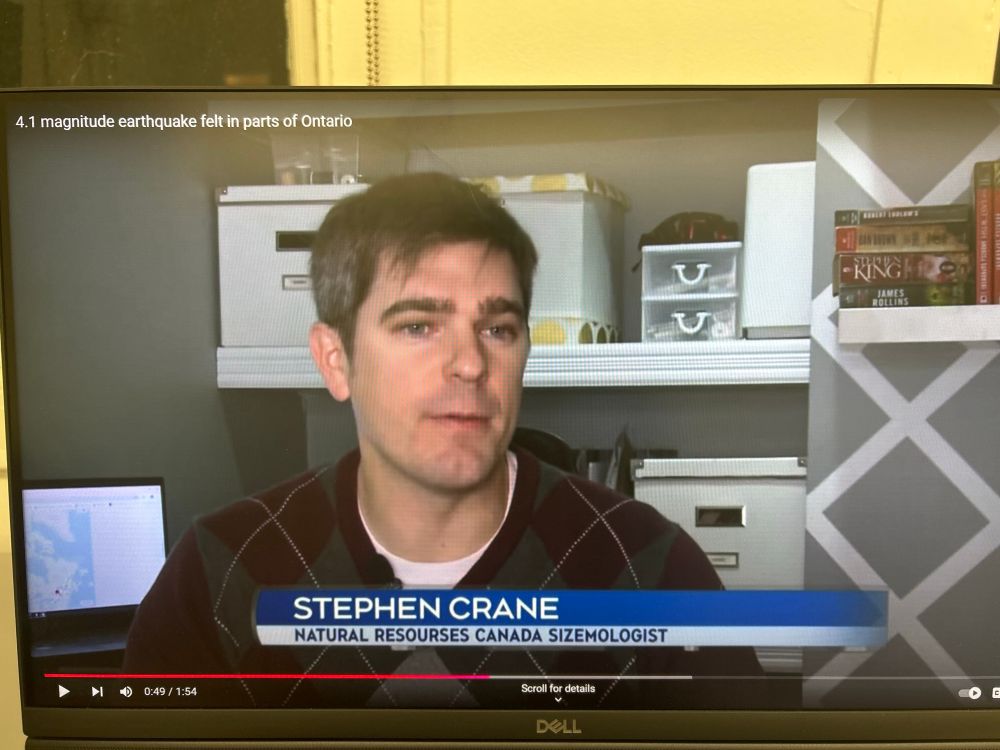 A photograph of a computer monitor, displaying a video from CTV News titled “4.1 magnitude earthquake felt in parts of Ontario”. 

The photo features a man named Stephen Crane from Natural Resources Canada talking to the camera explaining the earthquake. The text at the bottom of the video states Stephen Crane’s name, organization (Natural Resources Canada), and position (seismologist).